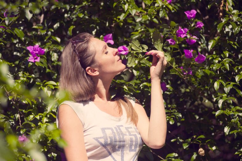 woman sniffing flower